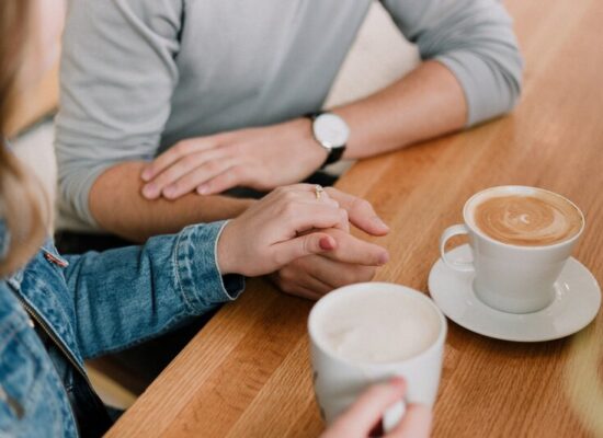 couple talking and holding coffee mugs